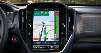 An in-dash Subaru Multimedia touchscreen displaying a Subaru Navigation real-time map.