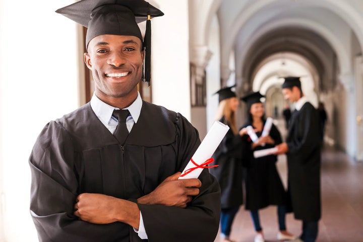 college graduate holding his diploma | Flow Subaru in Winston-Salem NC